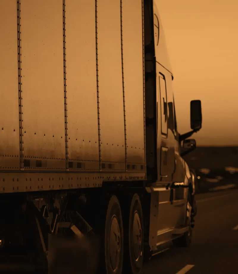 Truck and trailer on the highway at dusk